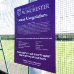 Winchester University Sports Stadium purple and white ACM rules & regs sign on fence
