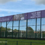 Winchester University Sports Stadium purple and white mesh banner on fence