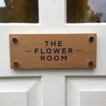 The Flower Room blue cut vinyl lettering on wooden door sign