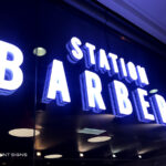 Station Barbers illuminated letters in window
